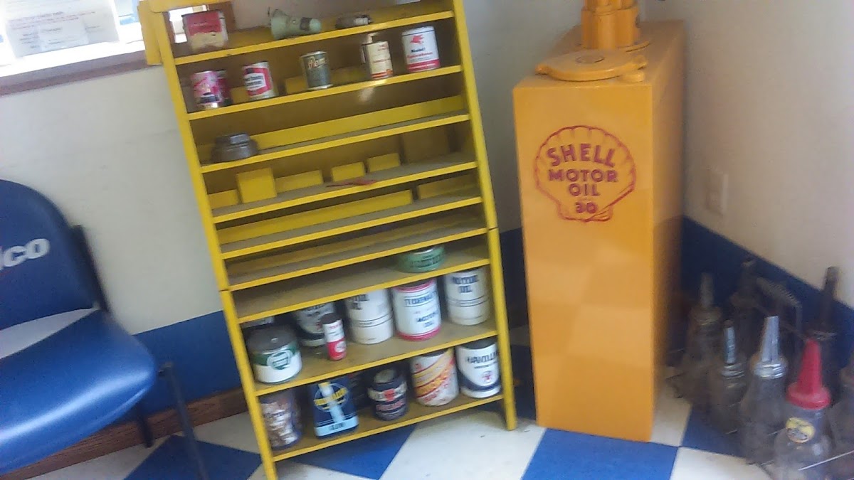 The J & B Automotive waiting room with a vintage oil-can collection